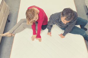 father and son sitting on a mattress