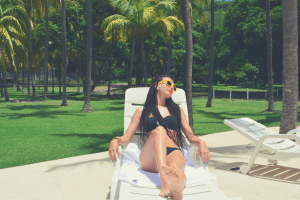 braided woman lying in a recliner