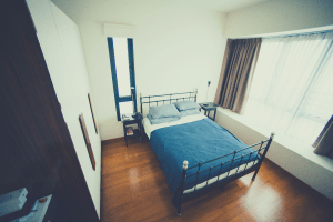 metal bed frame with blue and white bedshets