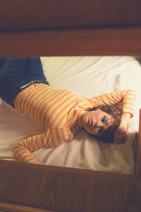 lady lying in bed with no pillow