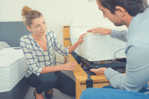 couple in a showroom discussing the right mattress height to order