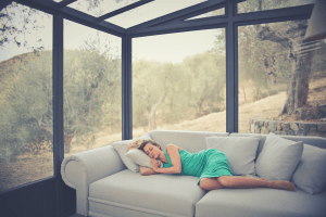 woman in green dress sleeping in the sofa