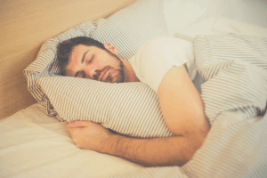 man lying on the side in bed